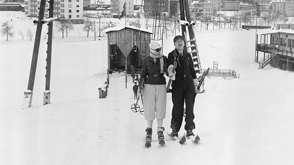 Zwei Skifahrer 1964 auf dem Skilift Bolgen in Davos. Als weltweit erster modernen Skilift mit Bügel wurde er am 24. Dezember 1934 eröffnet.