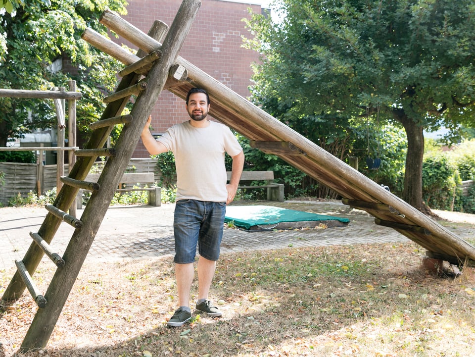 Ein junger Mann mit Shorts auf einem Spielplatz.