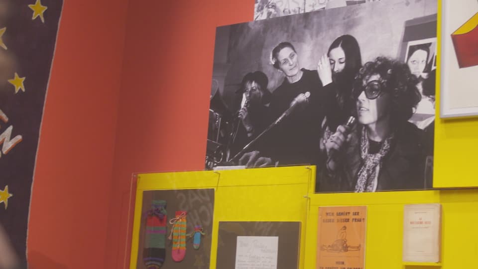 Schwarz-weiss-Foto an der Wand mit Frauen am Mikrofon.