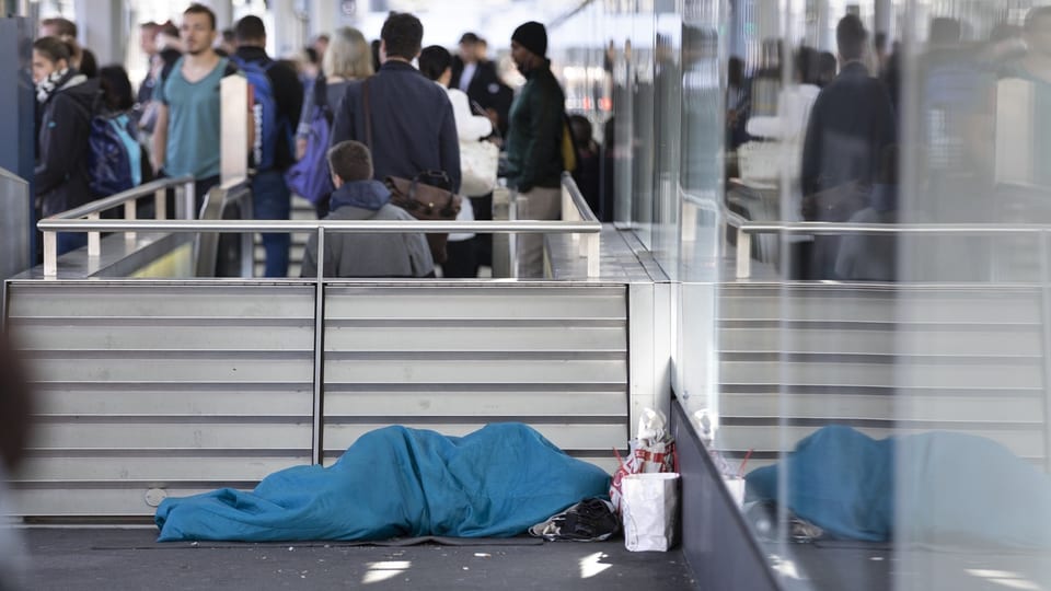 Ein Obdachloser schläft am Boden in Zürich.