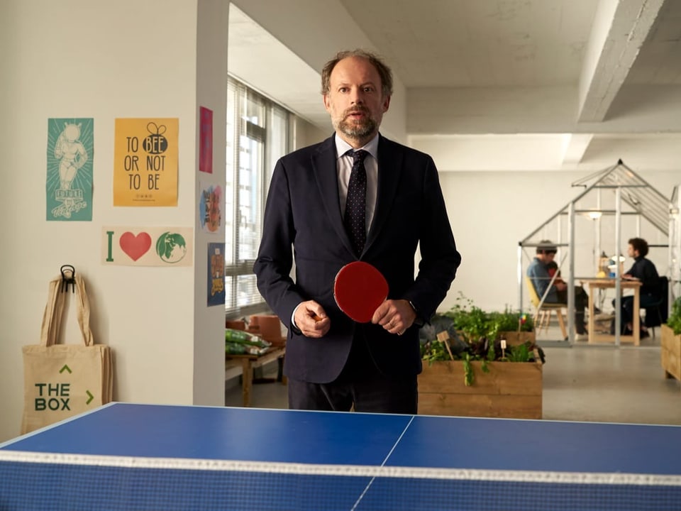 Mann im Anzug spielt Ping-Pong