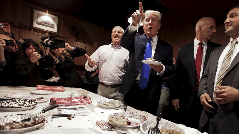 Trump mit Kuchen in der Hand.