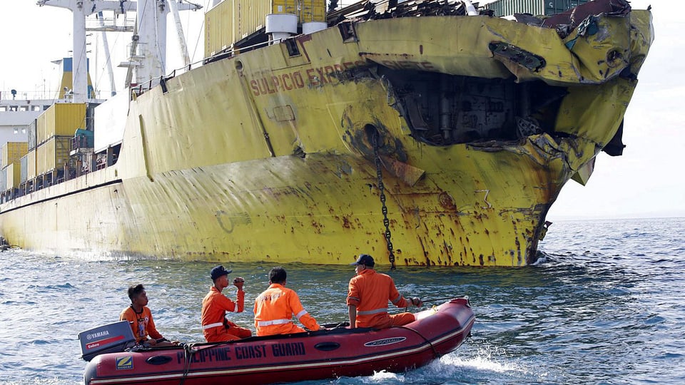 Rettungsboot vor beschädigtem Frachter