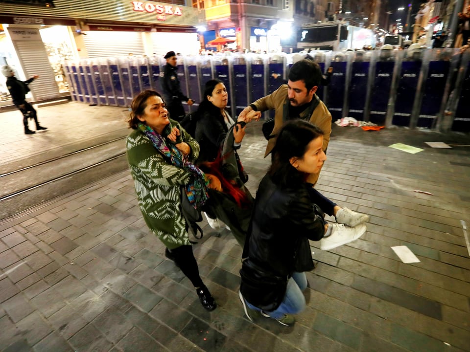 Demonstranten in Istanbul tragen eine verletzte Frau weg.