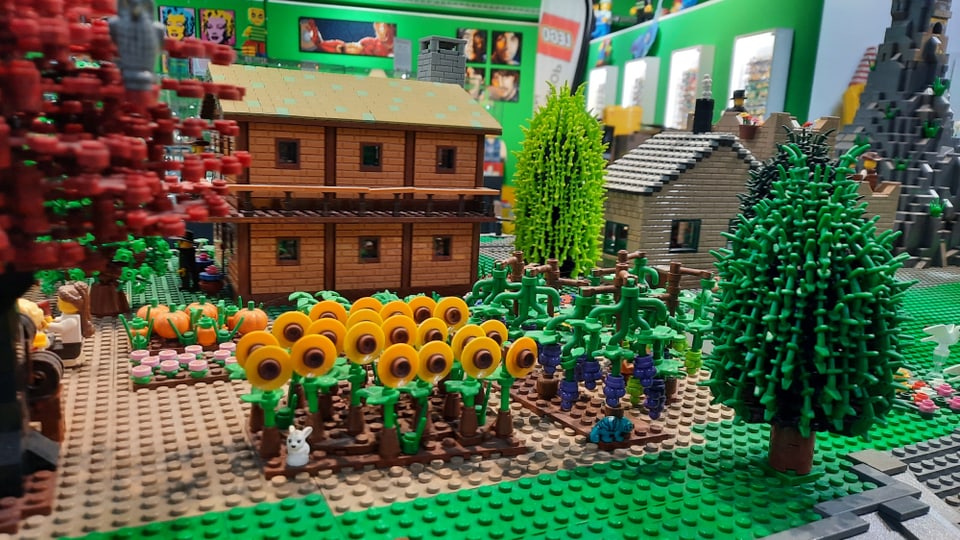 A farm with flowers and trees made from Lego