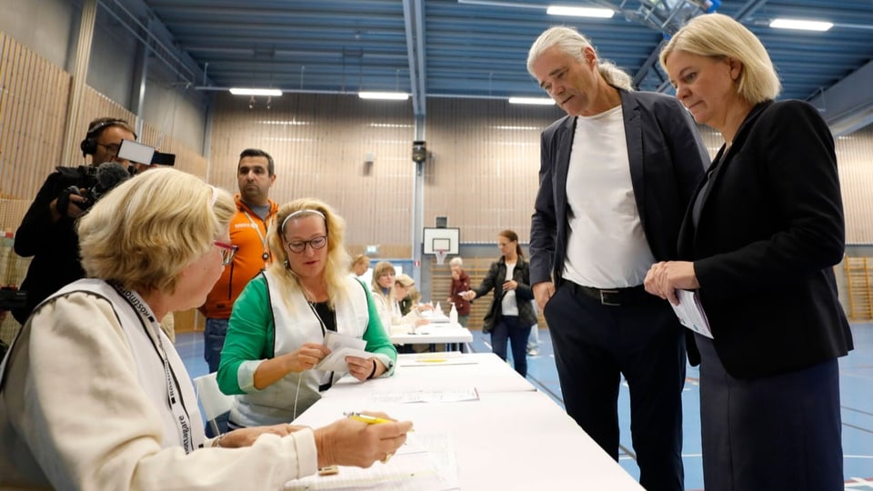 Woman in front of voter's table.