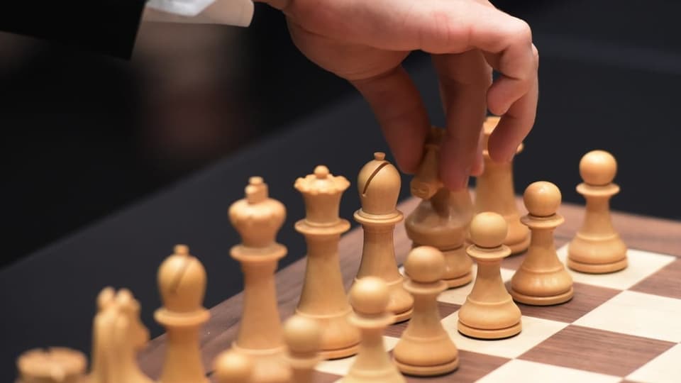 Schachspieler bewegt Figuren