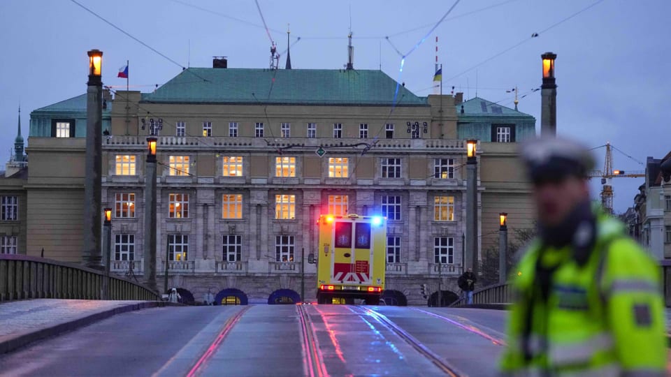 Blick auf das Universitätsgebäude, während sich ein Rettungswagen nähert.