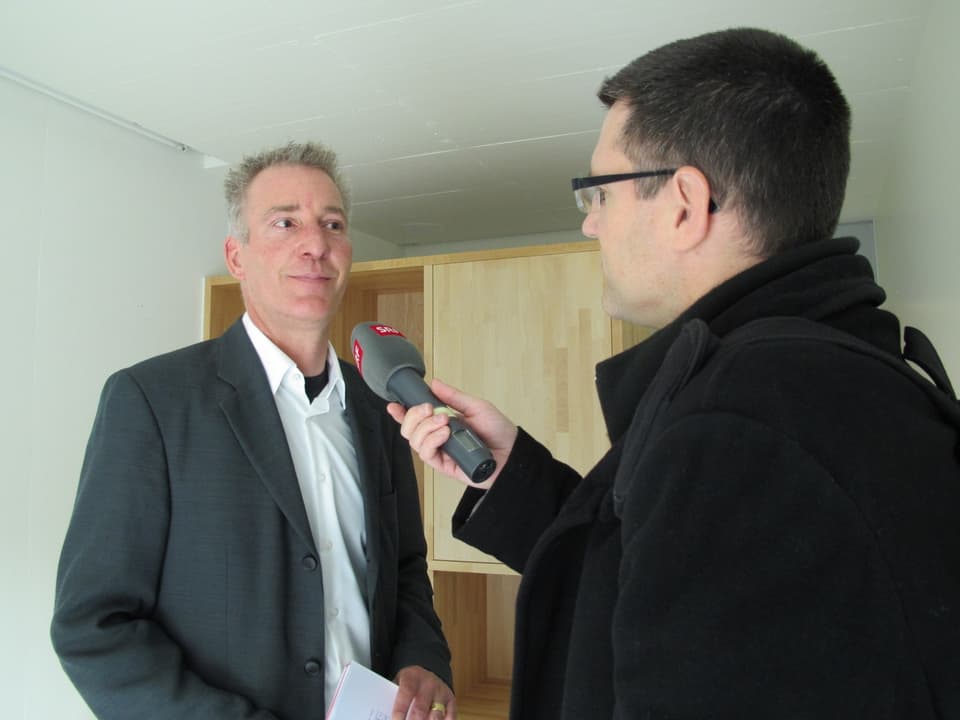 SRF-Reporter Marco Jaggi interviewt in einer Zelle David Brunner, den Gesamtprojektleiter des Neubaus.