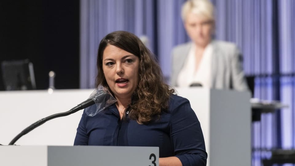 Eine Frau spricht in auf einem Podium.