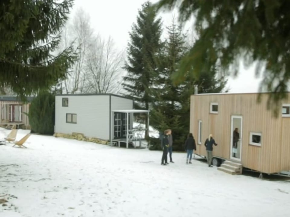 Drei Tiny Häuser im Schnee.