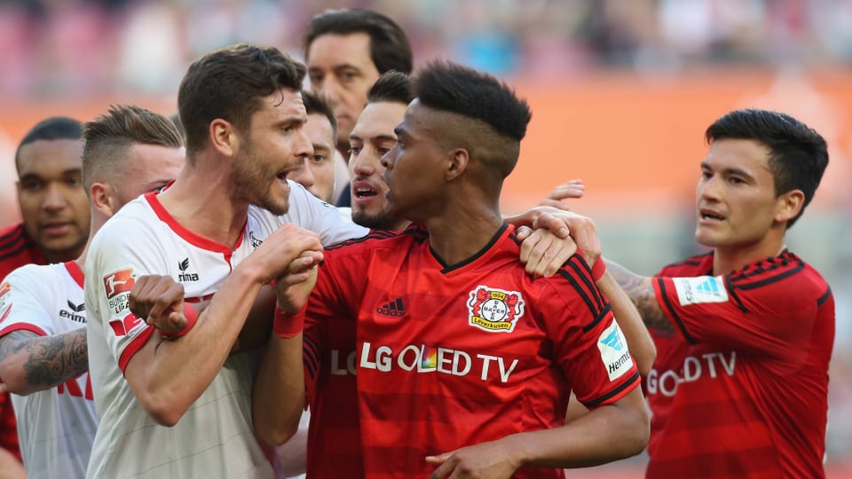 Köln-Spieler Jonas Hector und Leverkusens Wendell sagen sich die Meinung. 