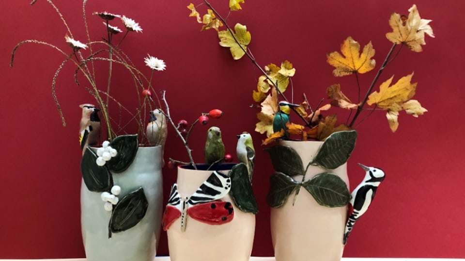 Drei Vasen kunstvoll mit Vögeln dekoriert.