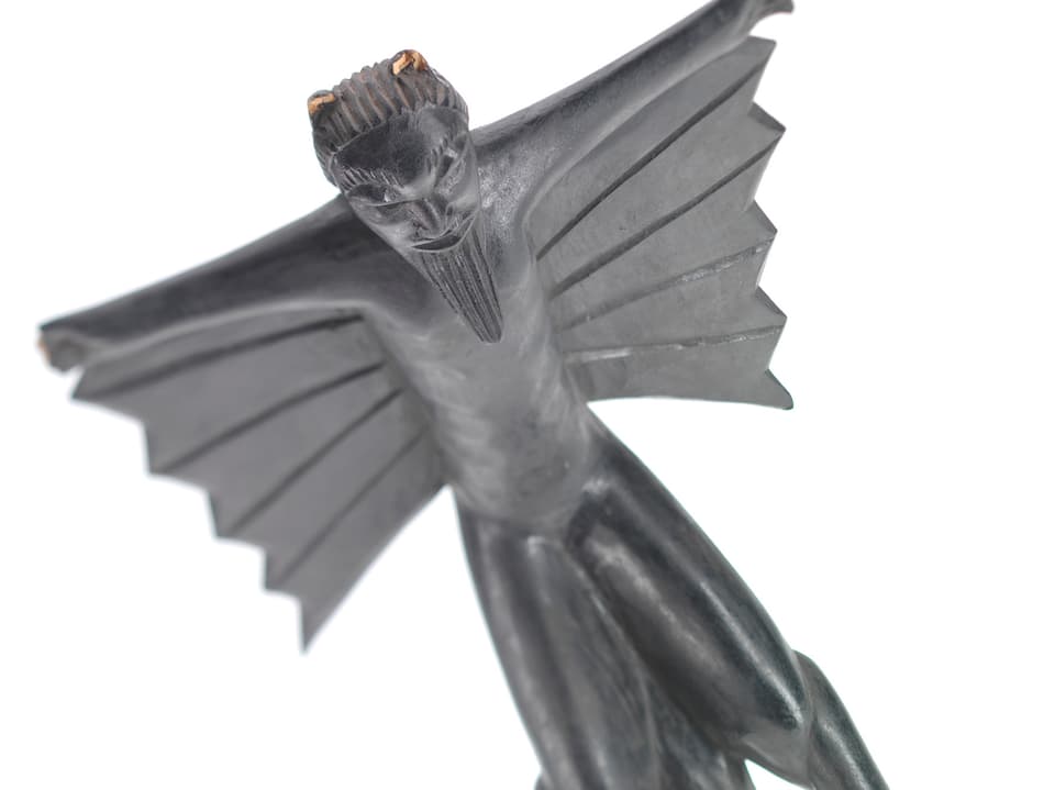 Eine schwarze Figur mit Flügeln.