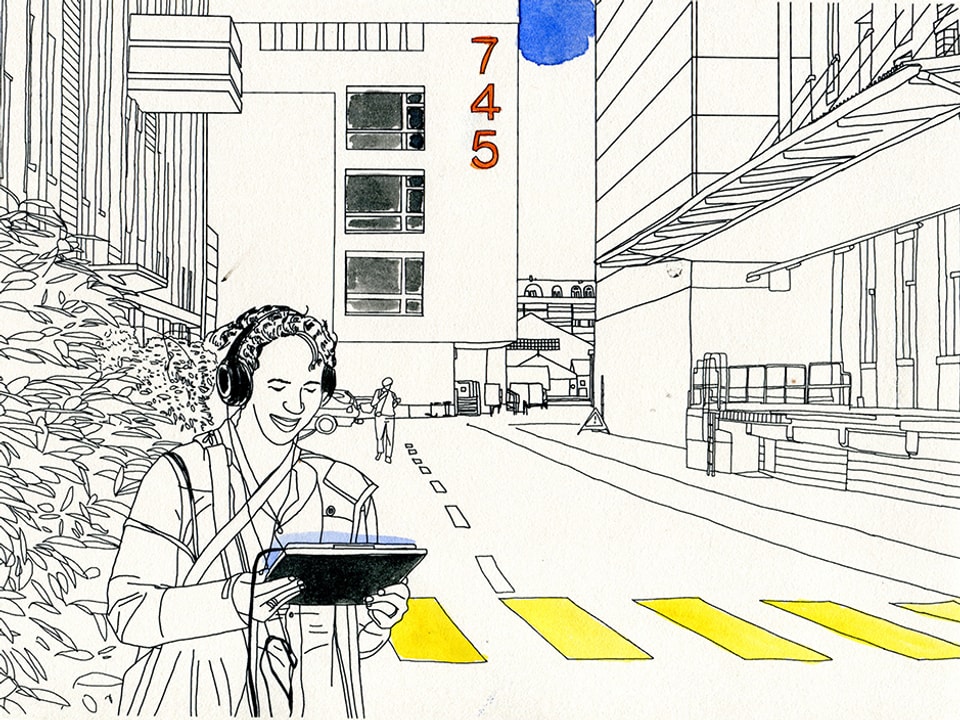 Eine Frau mit Kopfhörern und Tablet auf der Strasse, in das Tablet schauend.