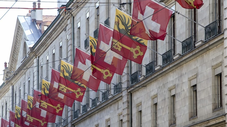 Mit Genfer und Schweizer Fahnen beflaggte Fassade in Genf.