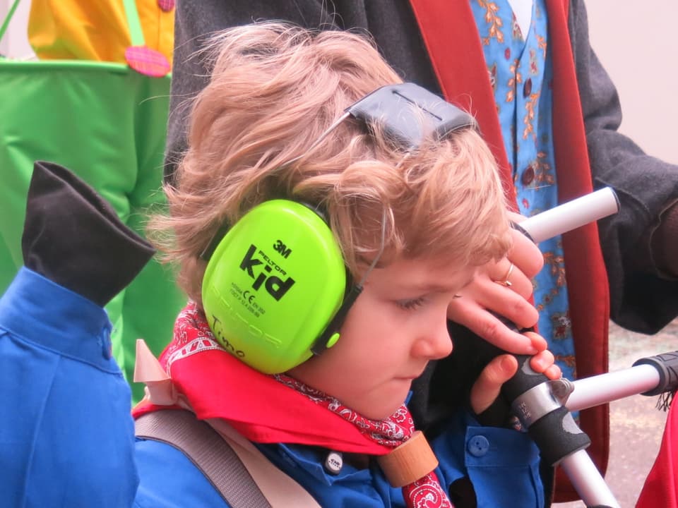 Kind mit grünem Gehörschutz