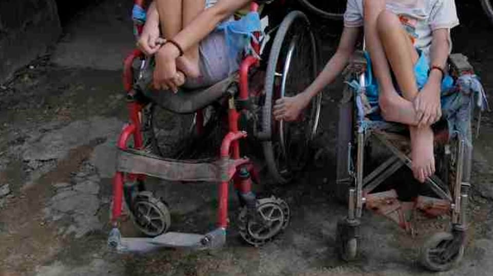 Zwei behinderte Kinder in Rollstühlen.