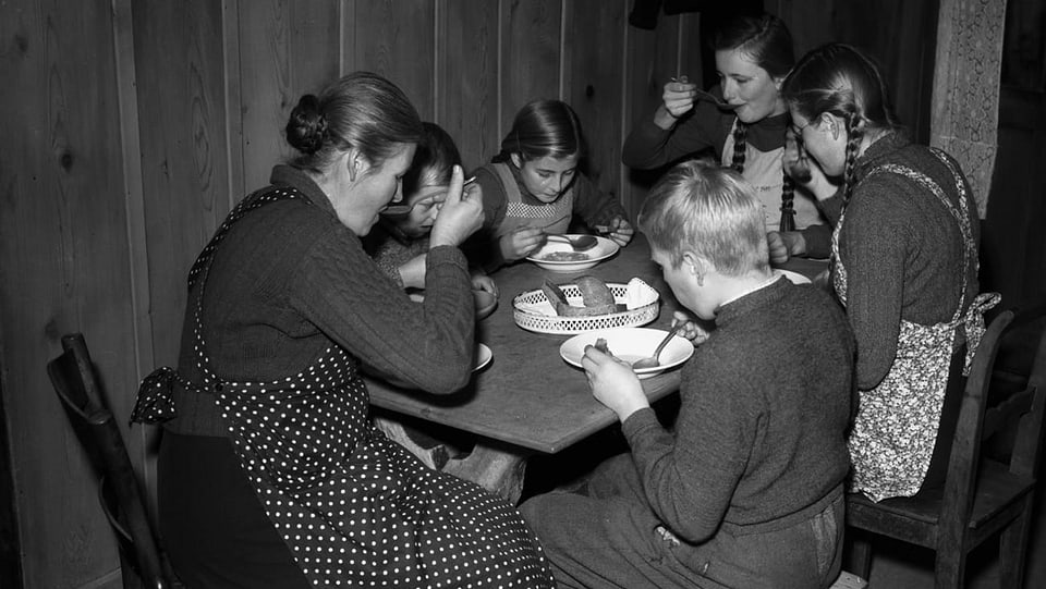 Eine Familie lässt sich zuhause am Mittagstisch die Suppe schmecken. 