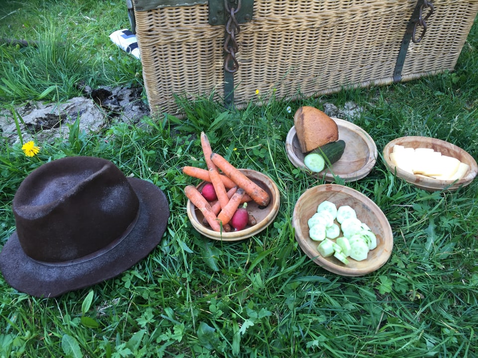 Holzschalen mit Karotten, Gurken und Brot liegen bereit. 