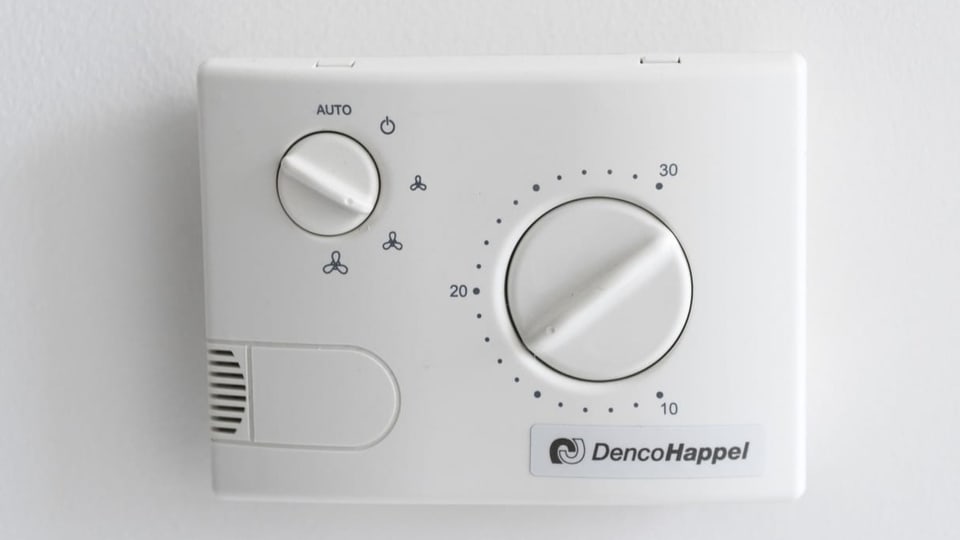 Ein Thermostat hängt an der Wand.