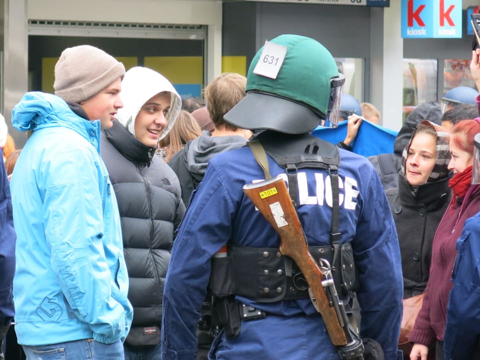 Jugendliche sprechen mit einem Polizisten
