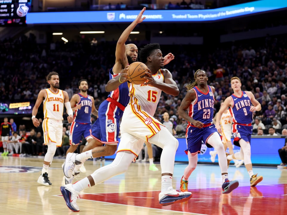 Basketball game, Player with ball while dribbling.