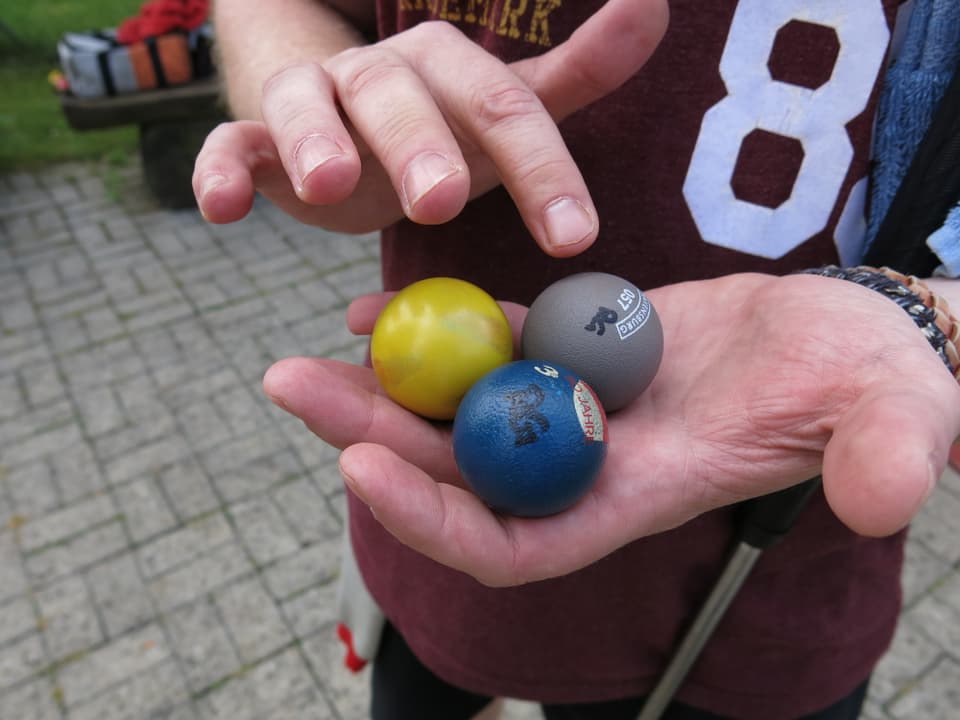 Drei unterschiedlich lackierte Minigolfbälle.