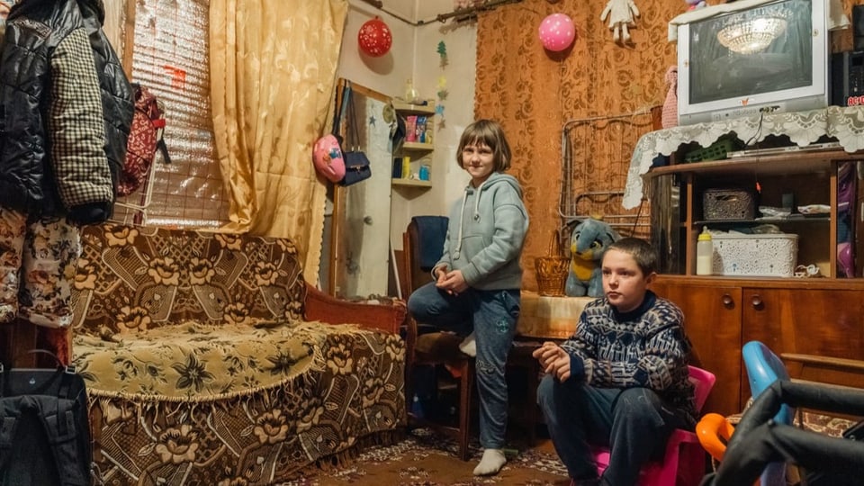 Ein zehnjähriger Knabe und ein siebenjähriges Mädchen im Wohnzimmer
