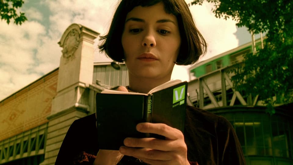 Audrey Tautou liest in einem Buch im Film Die fabelhafte Welt der Amélie