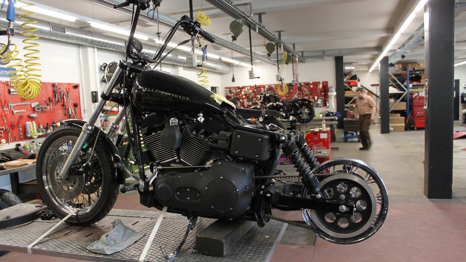 Eine Harley in der Werkstatt - das Hinterrad fehlt. 