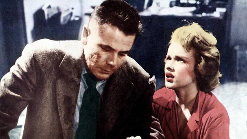 Die Filmszene, die nachkoloriert wurde, zeigt Glenn Ford und Anne Francis.