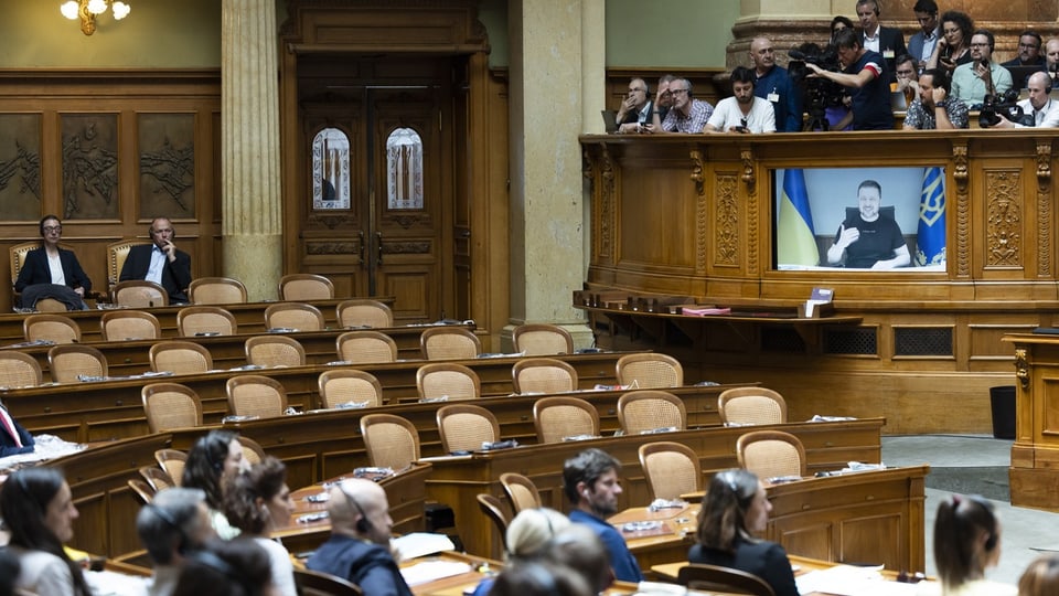 Volle und leere Stühle im Nationalratssaal, Selenski in Videoübertragung