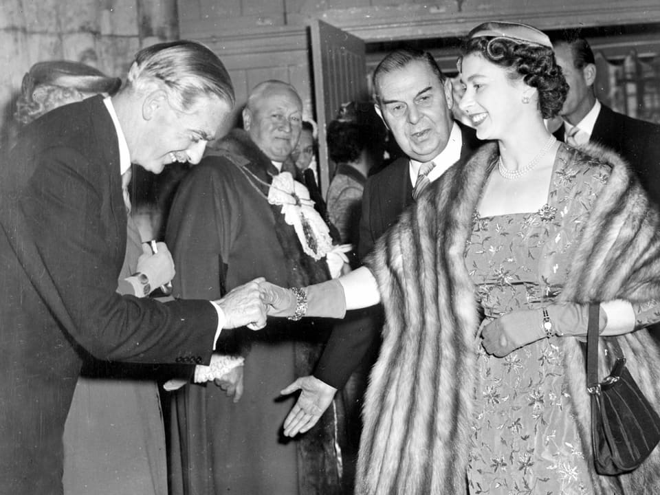 Die Königin begrüsst einen Mann mit einem Handschlag.