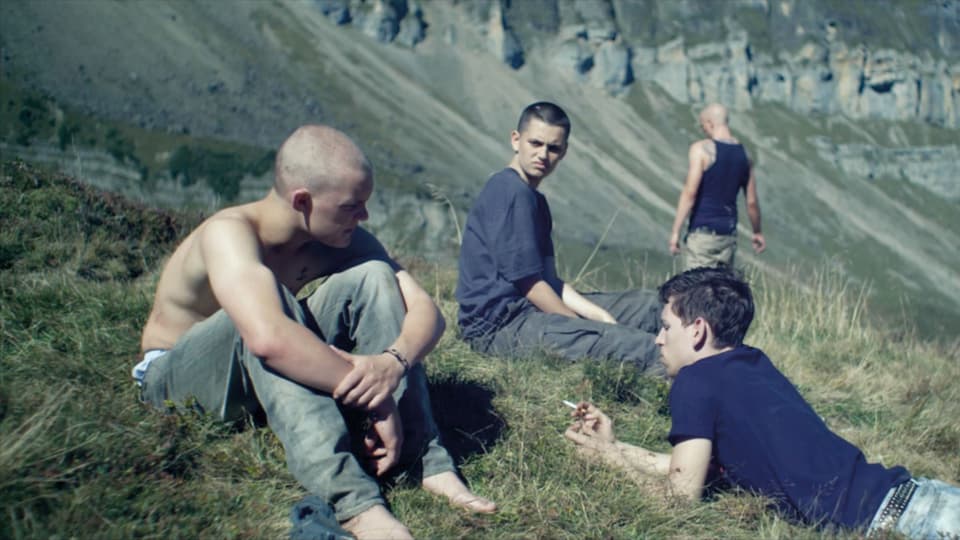 Jugendliche auf einer Bergwiese.