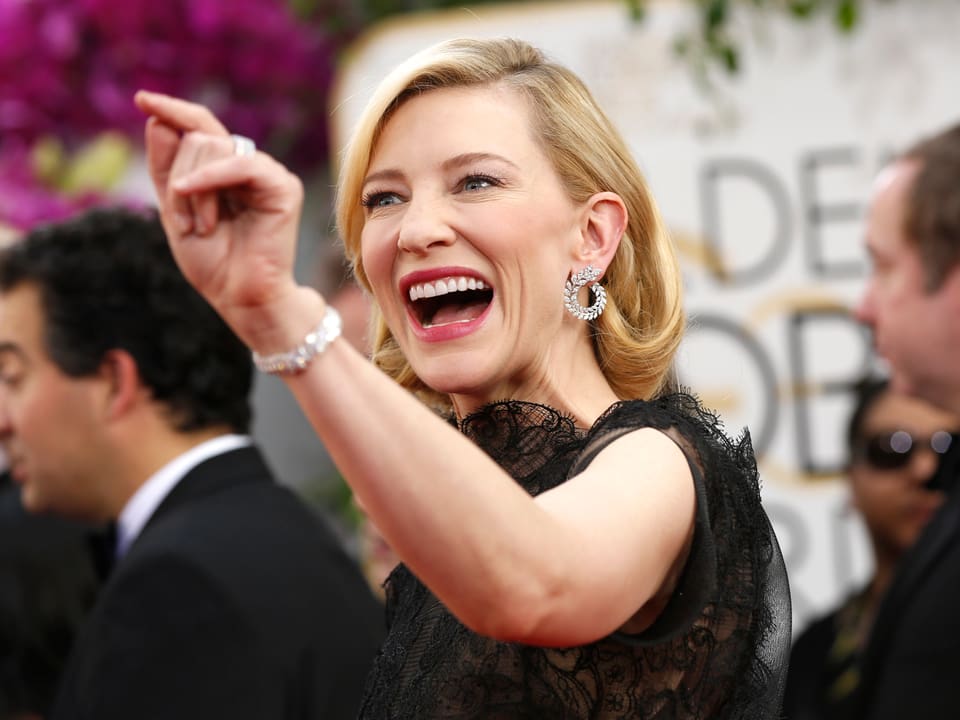 Schauspielerin Cate Blanchett lacht und gestikuliert auf dem Roten Teppich.