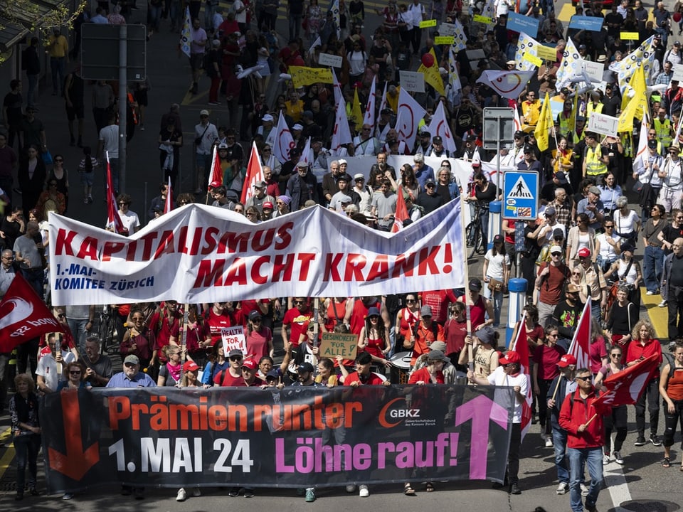 Demonstration mit Transparenten gegen Kapitalismus und für höhere Löhne