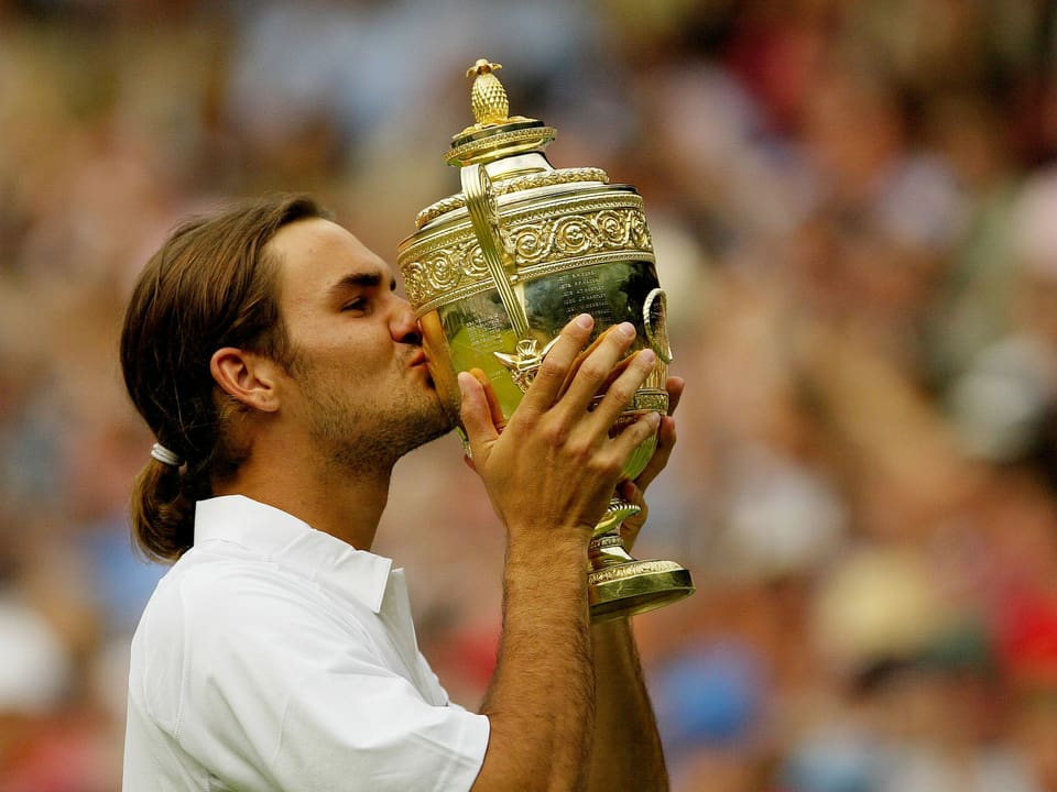 Roger Federer küsst seine 1. Wimbledon-Trophäe.