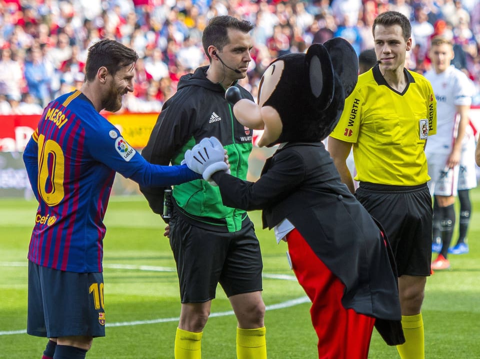 Lionel Messi schüttelt Mickey Mouse die Hand