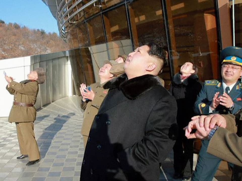Kim Jong Un und seine Getreuen schauen in den Himmel