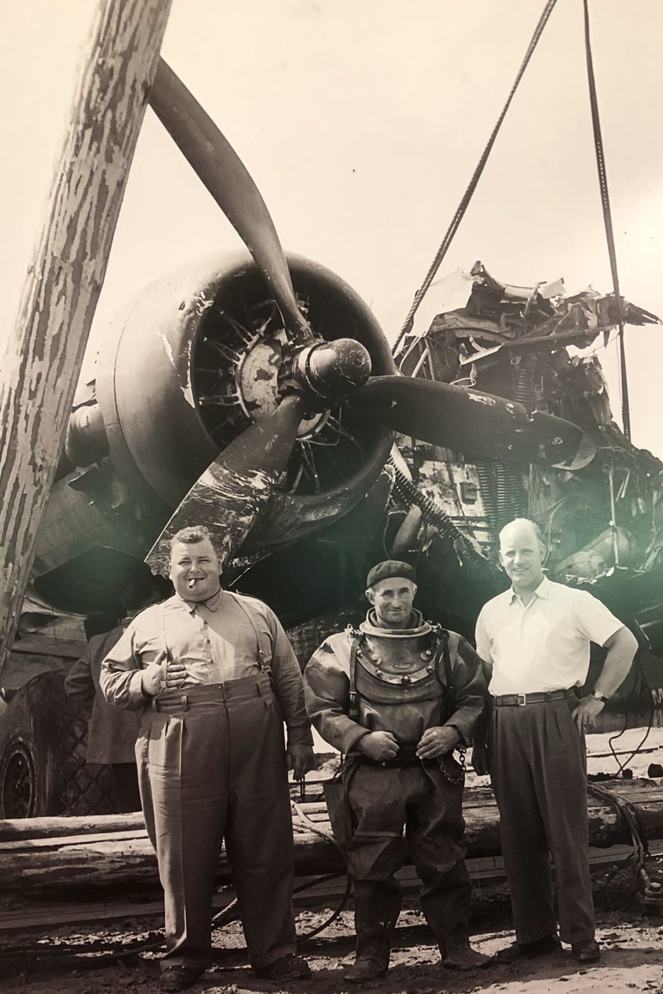 Martin Schaffner, Tuacher Gottfried Scherrer und Josef Schnellmann stehen vor dem Flugzeugwrack.