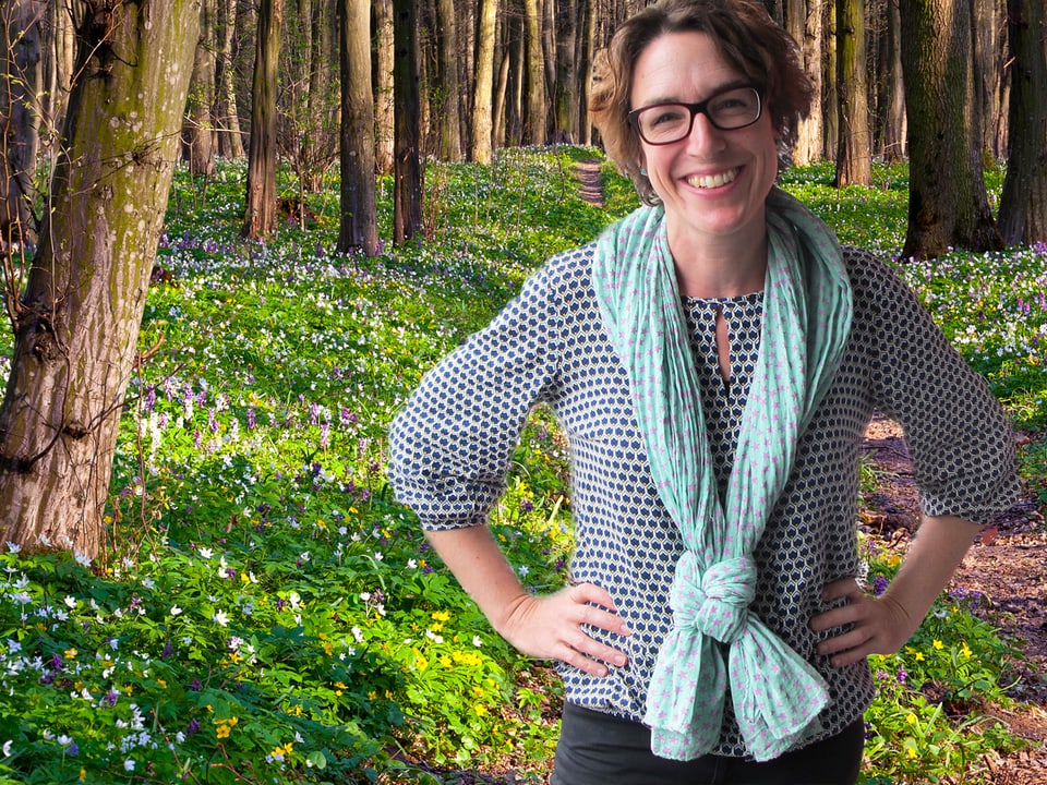 Joelle Beeler trägt einen Schal mit Pfadfinder-Krawattenknopf im Wald (Bildmontage).