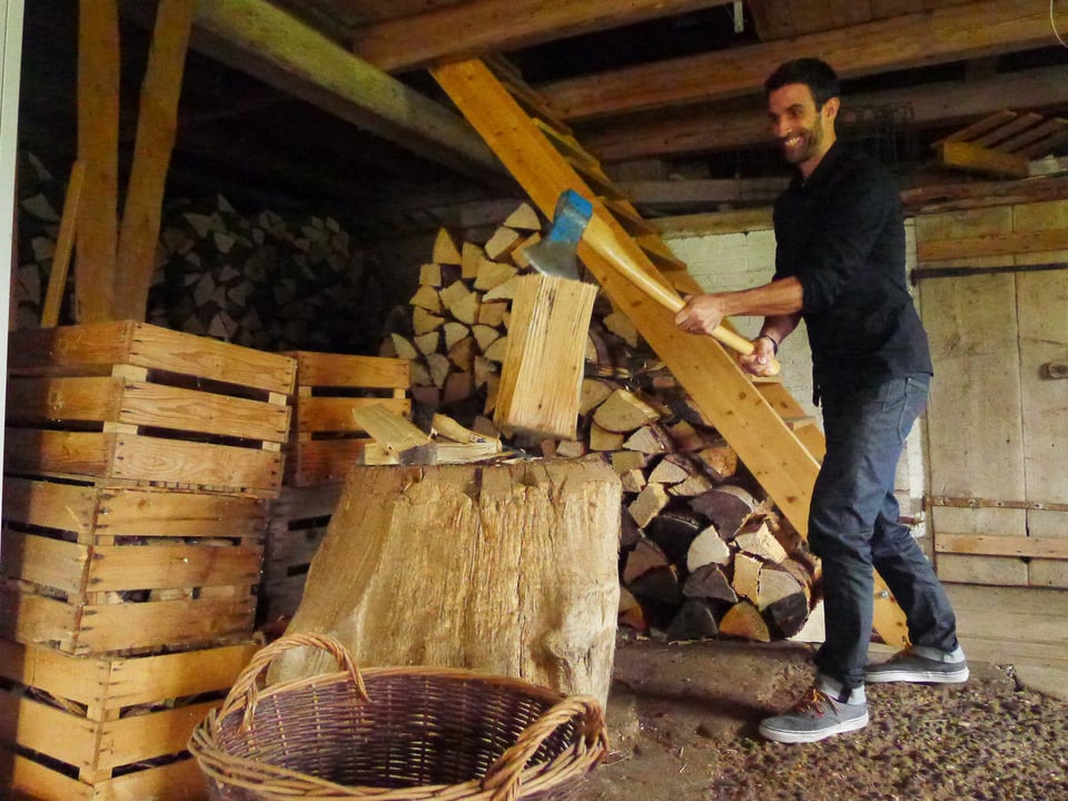 Bevor der Ofen eingefeuert werden kann wird Holz gehackt. SRF 3 Moderator Philippe Gerber legt selber Hand an. 