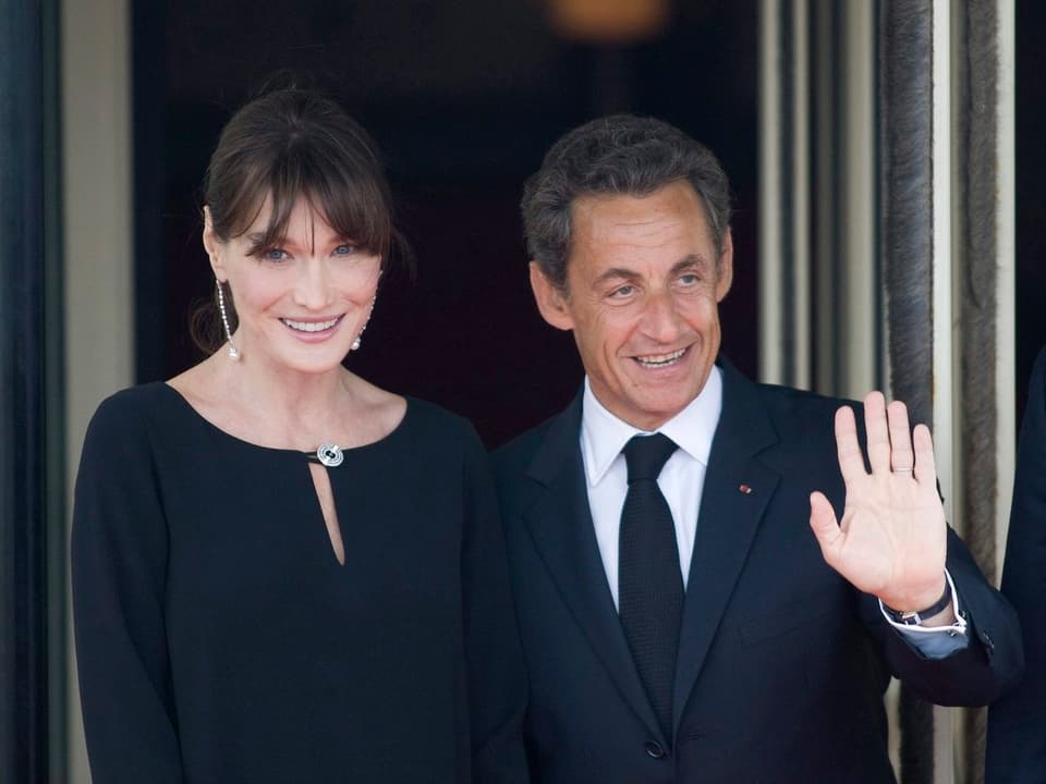 French president Nicolas Sarkozy (R) and his wife Carla Bruni (L) greet guests arriving for an evening dinner at the G8 summit in Deauville, France, on 26 May 26, 2011. The G8 summit comprises the U.S., Japan, France, Germany, Italy, Canada, the U.K. and Russia.