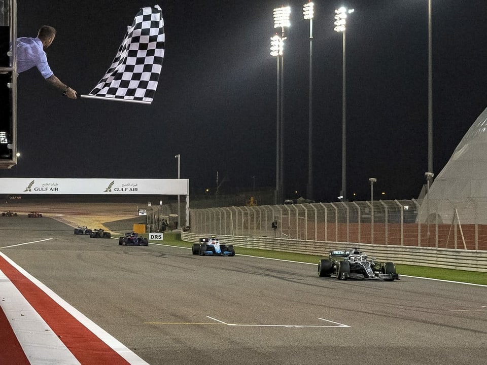 Formel-1-Boliden fahren in der Nacht in Bahrain.