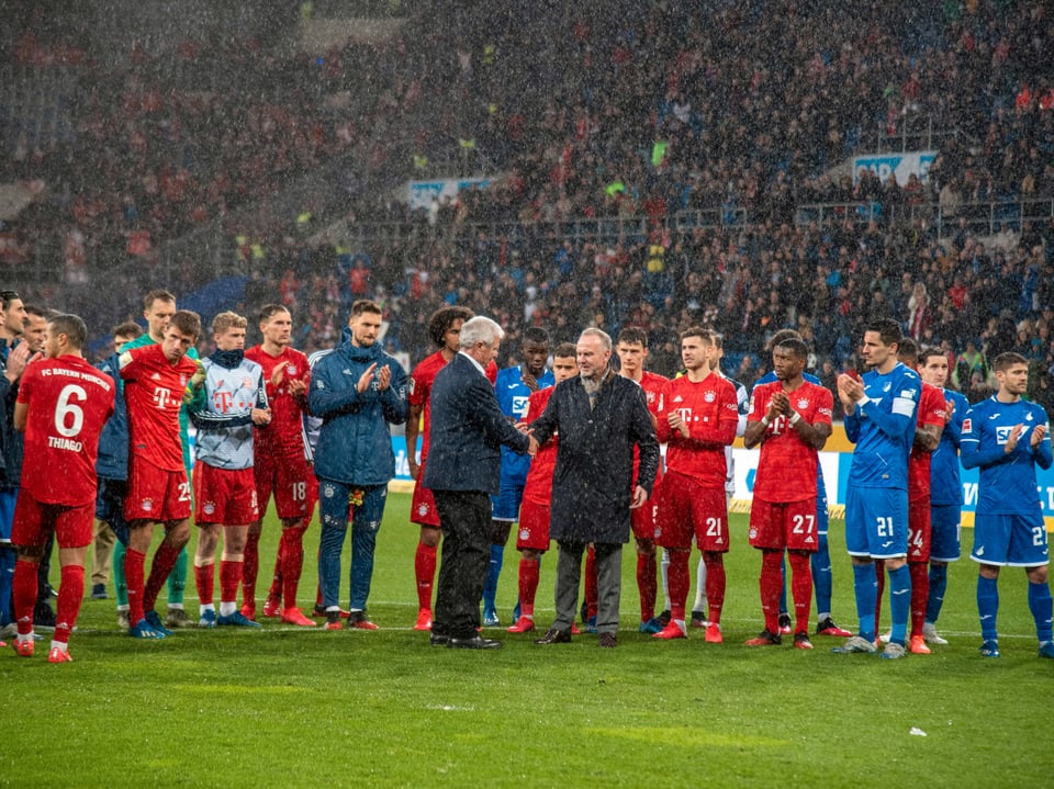 Bayerns Vorstandvorsitzender und Spieler beider Teams applaudieren Dietmar Hopp.