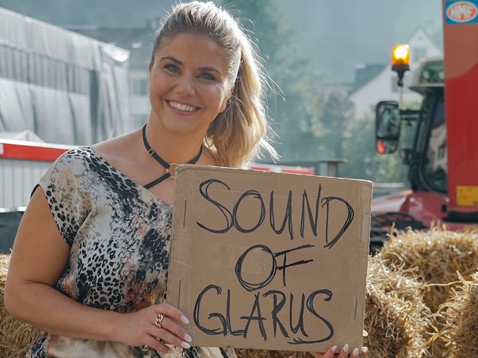 Beatrice Egli mit Schild auf welchem «Sound of Glarus» steht.