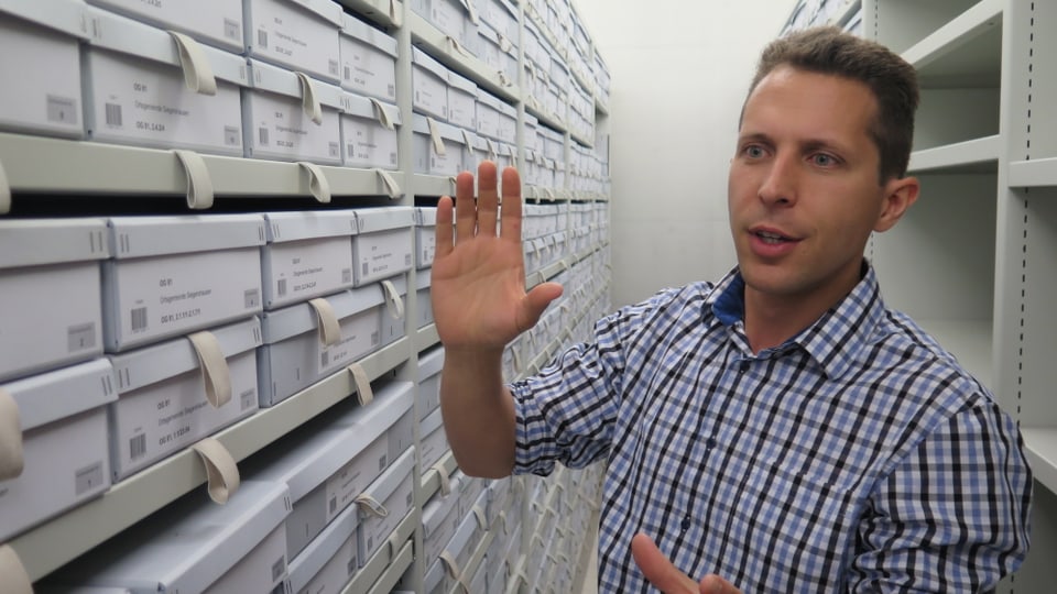 Adrian Oettli vom Staatsarchiv Thurgau steht vor vielen Schachteln mit Archiv-Dokumenten