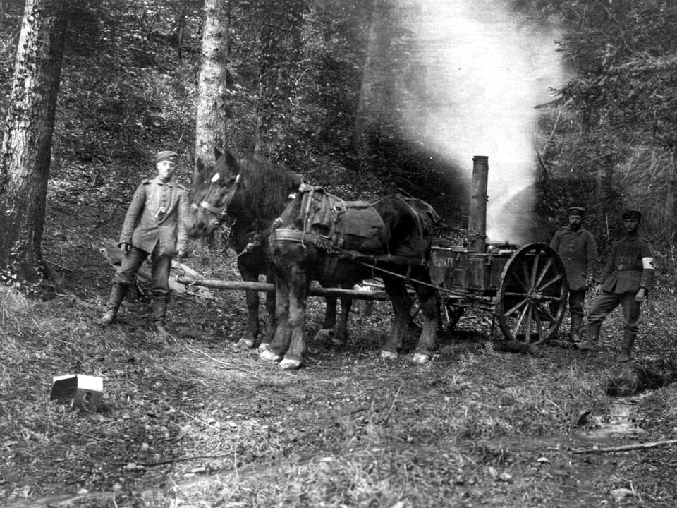 Männer mit einem Pferd, das eine rauchende Kanone hinter sich herzieht.