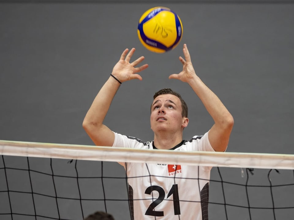 Der Schweizer Volleyballer Ramon Diem steht am Netz und spielt einen Ball.